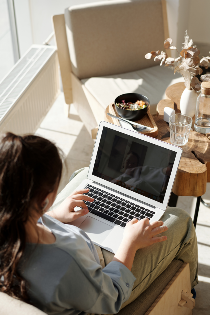 Woman sitting and turning on her laptop