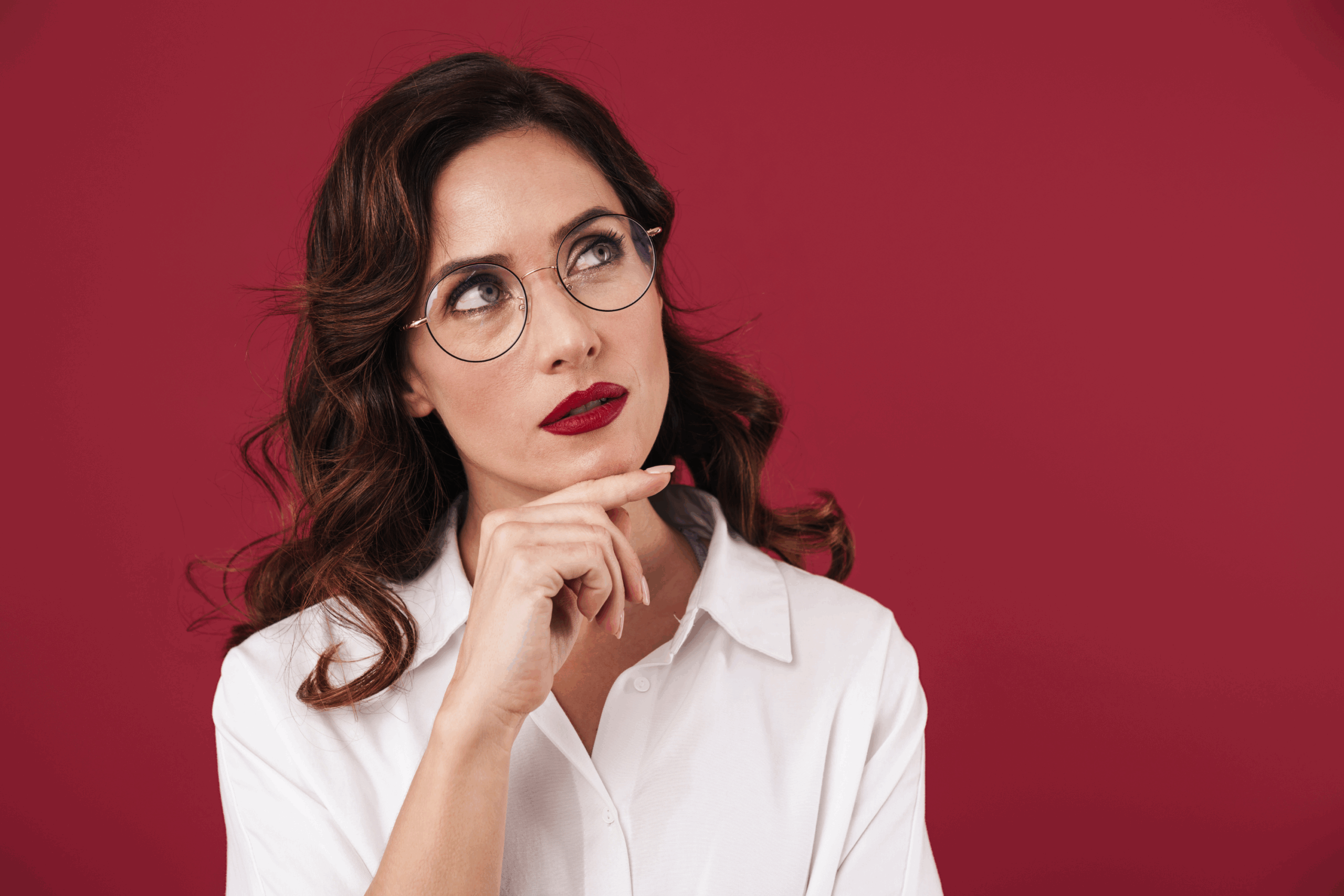 Woman thoughtfully looking up and away from camera
