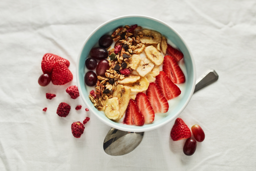 Picture of a yogurt bowl with fruits and trail mix.
