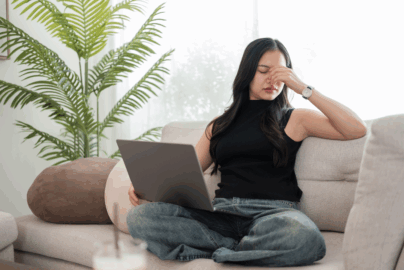 Frustrated women on a couch with laptop