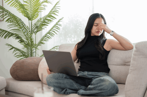 Frustrated women on a couch with laptop