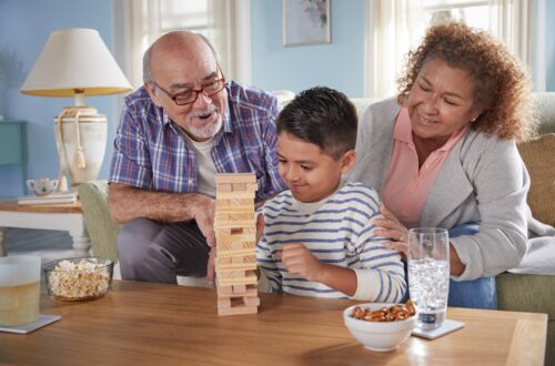 Grandparents and grandson playing games in living room